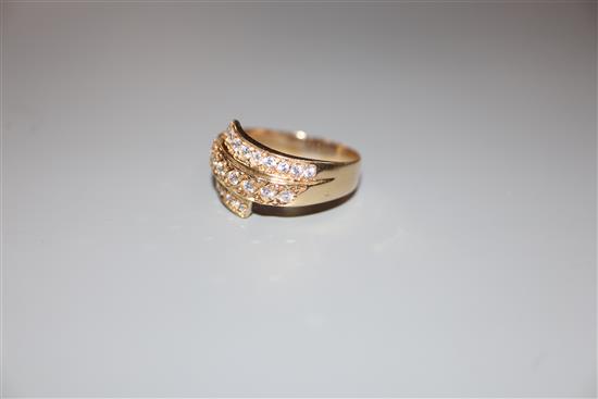 A modern 585 yellow metal and three row diamond set dress ring, size W, gross 5.2 grams.